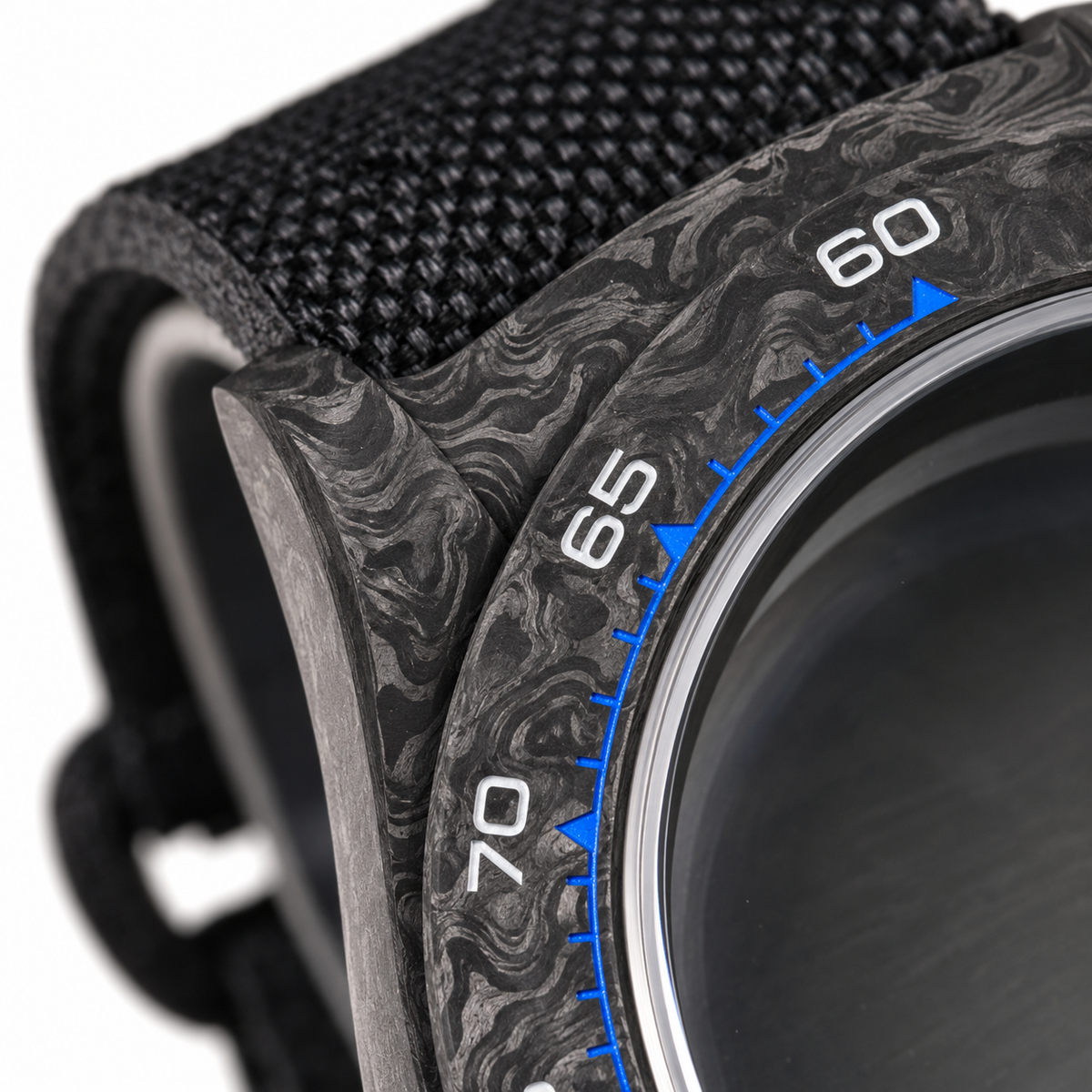 VK63 blue numeral black carbon case — carbon bezel and lug macro